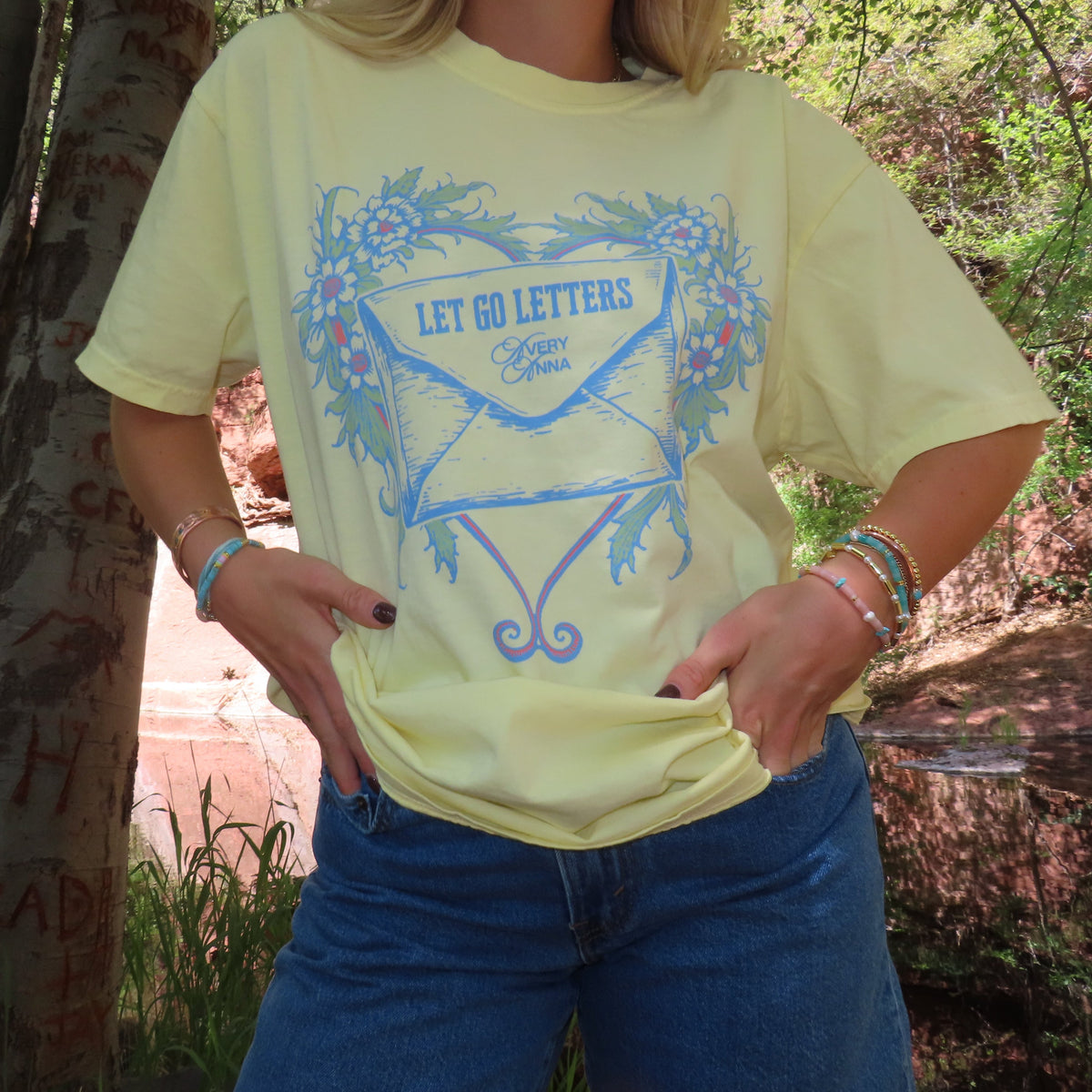 Let Go Letters tour tee in banana yellow with blue envelope artwork